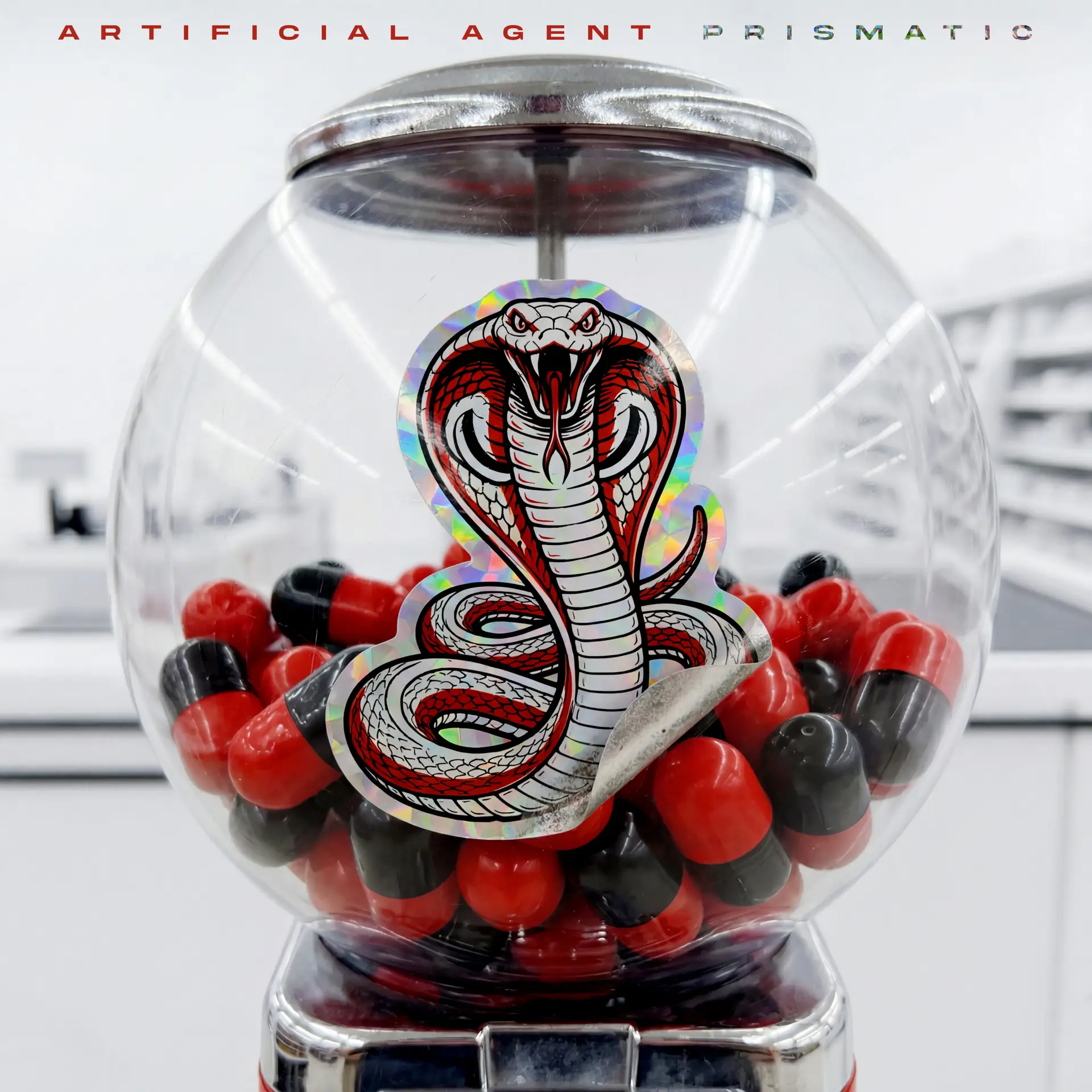 Close-up of a clear glass sphere containing red and black beads with a prominent cobra sticker on its surface and a silver base below.