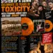 Promotional poster for System of a Downโs 25 years of Toxicity with orange vinyl, band photo, and crowd at bottom.